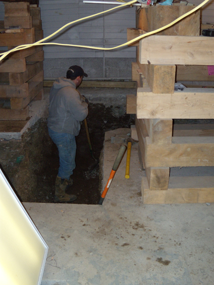 Looking from inside the Shaw kitchen towards Bird-Werner, in the background across the alley, at the location of the recycling bins in the summer. The trench is being finished off so the footing can be poured later that day.