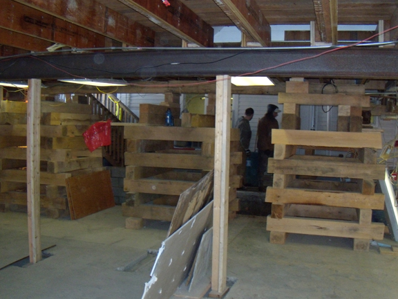 Looking from the Shaw kitchen towards Bird-Werner building (behind the two figures). In the foreground is the new east-west I-beam awaiting its new steel columns.